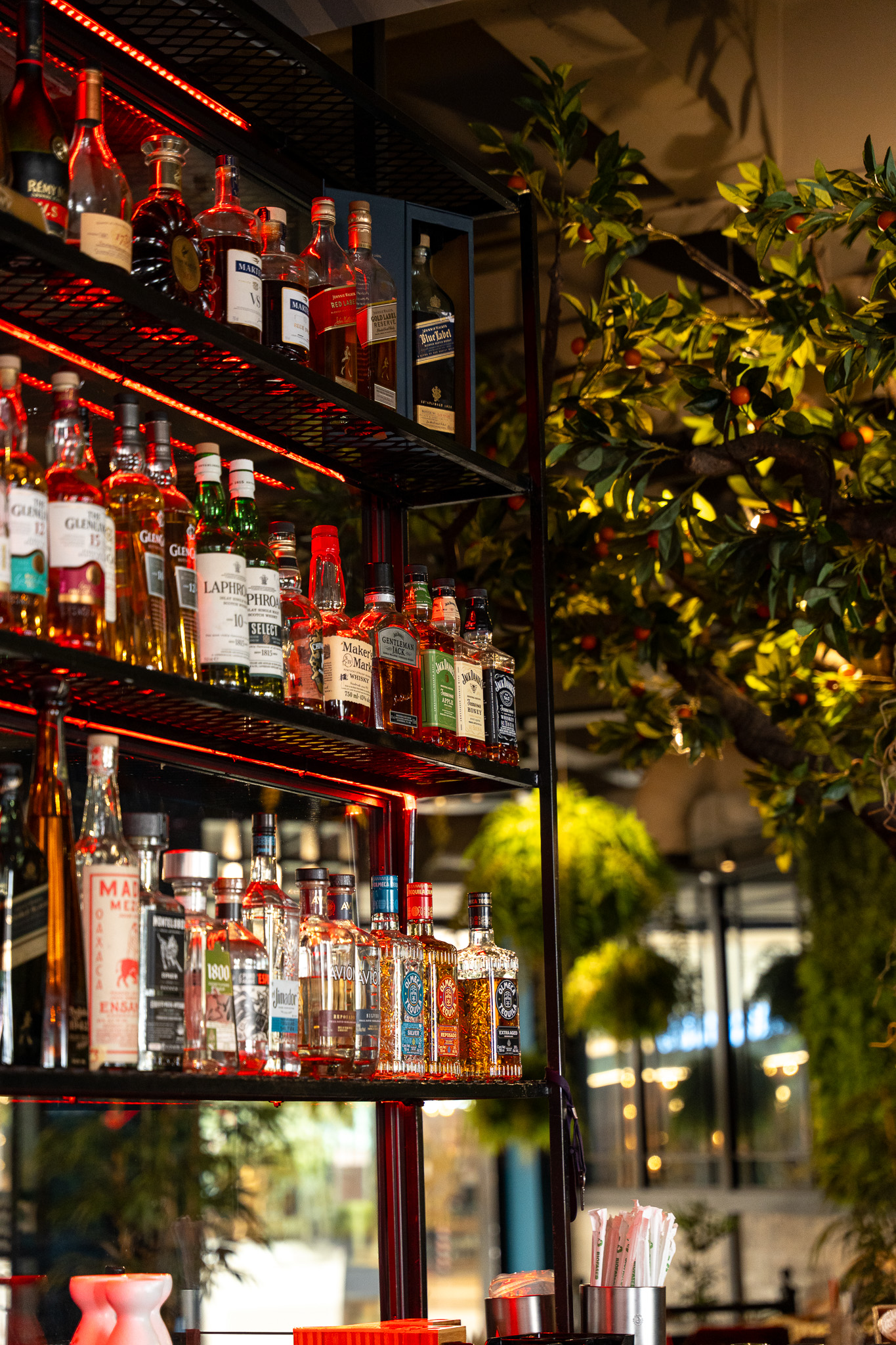 Chunky Chau Sandton on Instagram — Behind the backlit bottle wall.